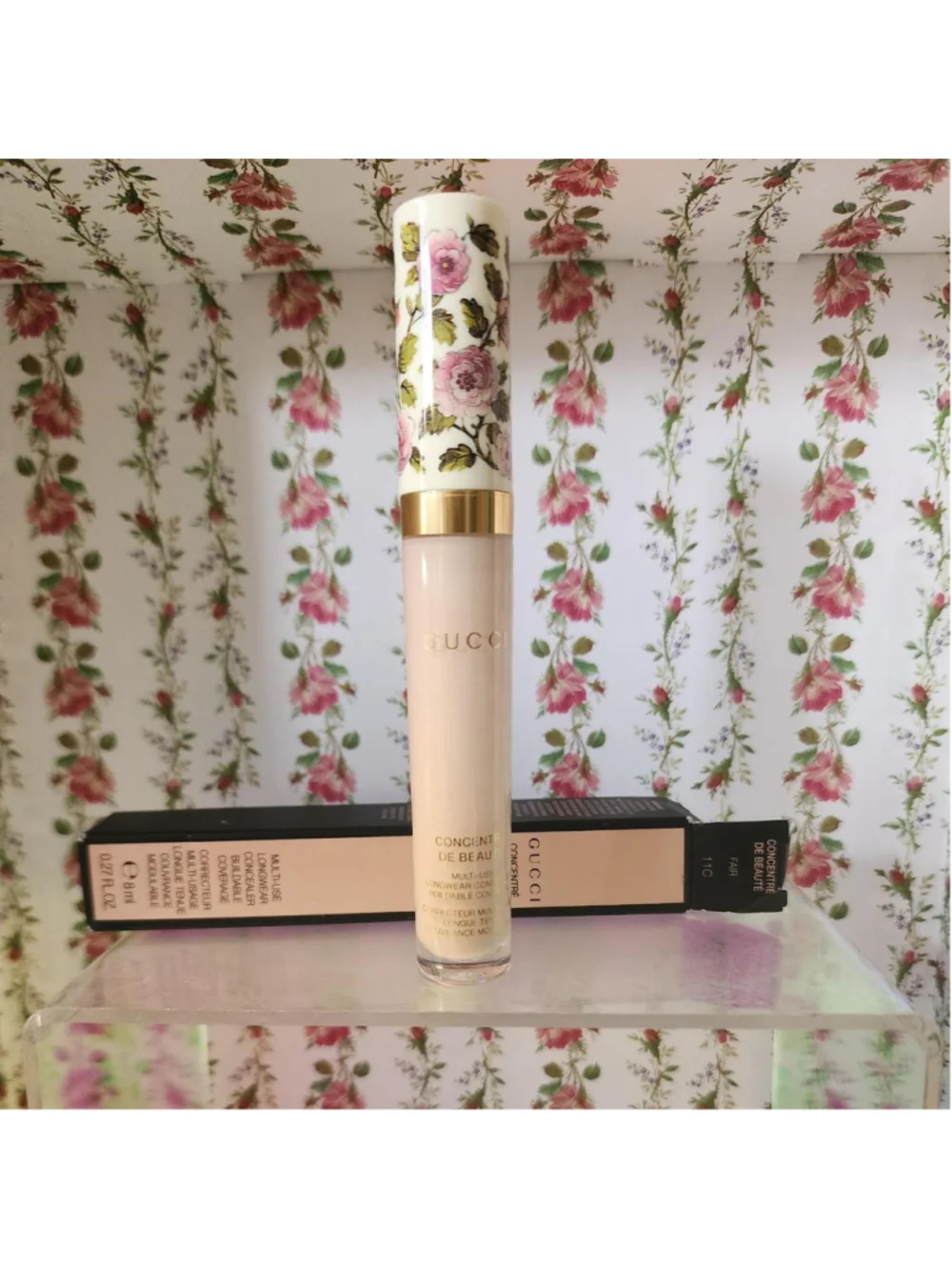 Gucci concealer with pink and green floral design on white background #gucci #fl